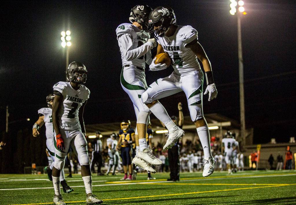 Jackson players celebrate a touchdown during a game on Sept. 28, 2018 in Everett, Wa. (Olivia Vanni / The Herald)