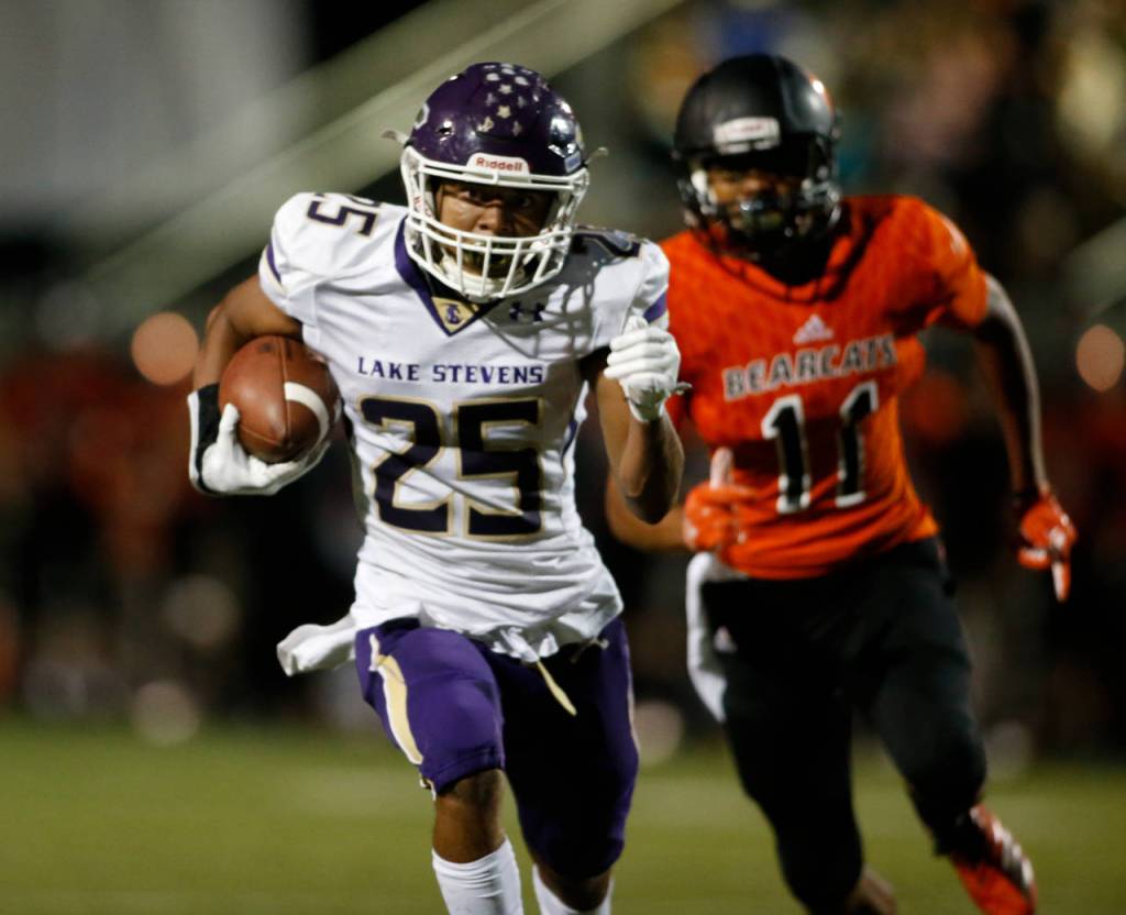 After making a catch Lake Stevens Kasen Kinchen runs to the end zone in a game against Monroe on Sept. 14, 2018 at Monroe High School. (Andy Bronson / The Herald)