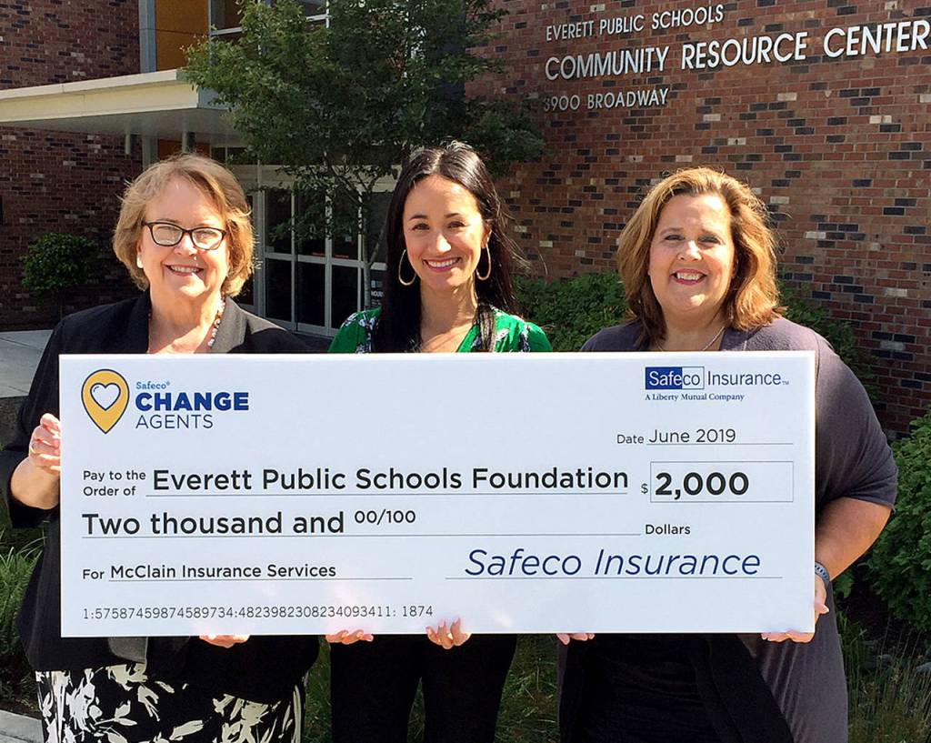 Claudia McClain, founder of McClain Insurance; Abby Roosendaal, senior territory manager at Safeco Insurance; and Kay Fantin, executive director of Everett Public Schools Foundation stand with a check for the EPS foundation. (Tilson PR)