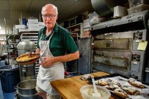 Andrew Abt is back and forth, from the kitchen to the sales counter, at Monroes Sky River Bakery Tuesday. He and his wife Mary Thorgerson have all they can handle and would like to sell the bakery and retire. (Dan Bates / The Herald)