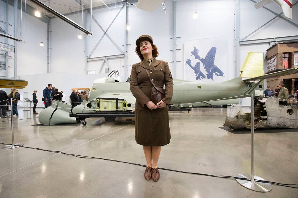 Marie Samson of Redmond poses for pictures in her World War II uniform in front of a Junkers Ju-87 Stuka at the Flying Heritage & Combat Armor Museum at Paine Field on Nov. 10, 2018 in Everett. (Andy Bronson / Herald file)