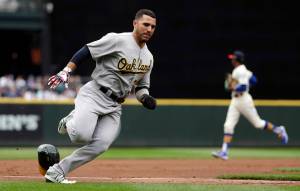 Oaklands Ramon Laureano races home to score against the Seattle Mariners in the first inning of Sundays game at T-Mobile Park in Seattle. (AP Photo/Elaine Thompson)