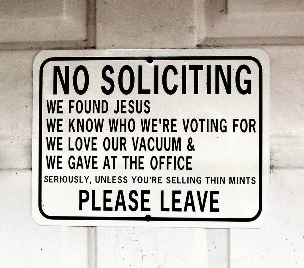 A sign posted on the former milk house, now coffeehouse, front door warns strangers to stay away. (Dan Bates / The Herald)