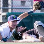 The AquaSoxs Cash Gladfelter (left) looks for the call after tagging the Volcanoes Medrona Robinson out at third base during a game on July 15, 2018, at Everett Memorial Stadium. (Kevin Clark / The Herald)