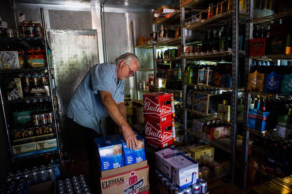 Doug Turner unloads and organizes his Friday beer delivery. (Olivia Vanni / The Herald)