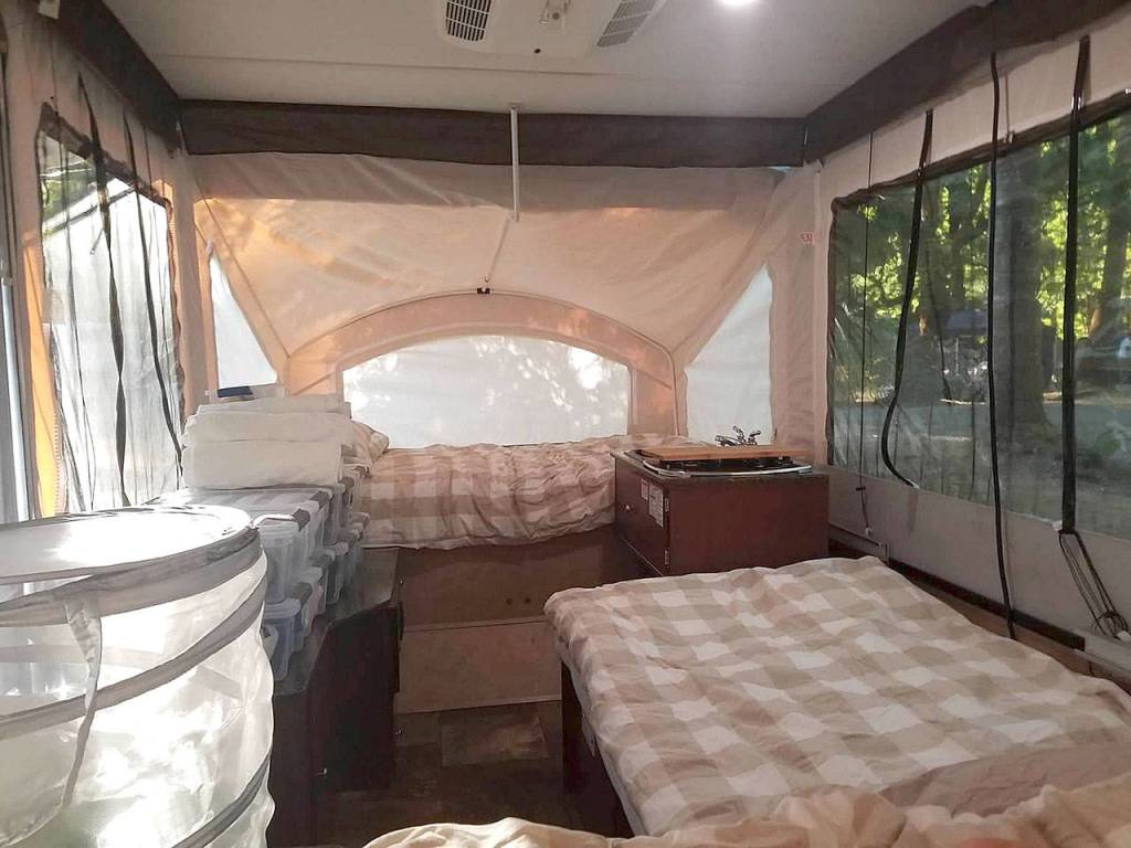 The Bardsley family uses storage bins from Costco as an impromptu dresser in their tent trailer. (Jennifer Bardsley)