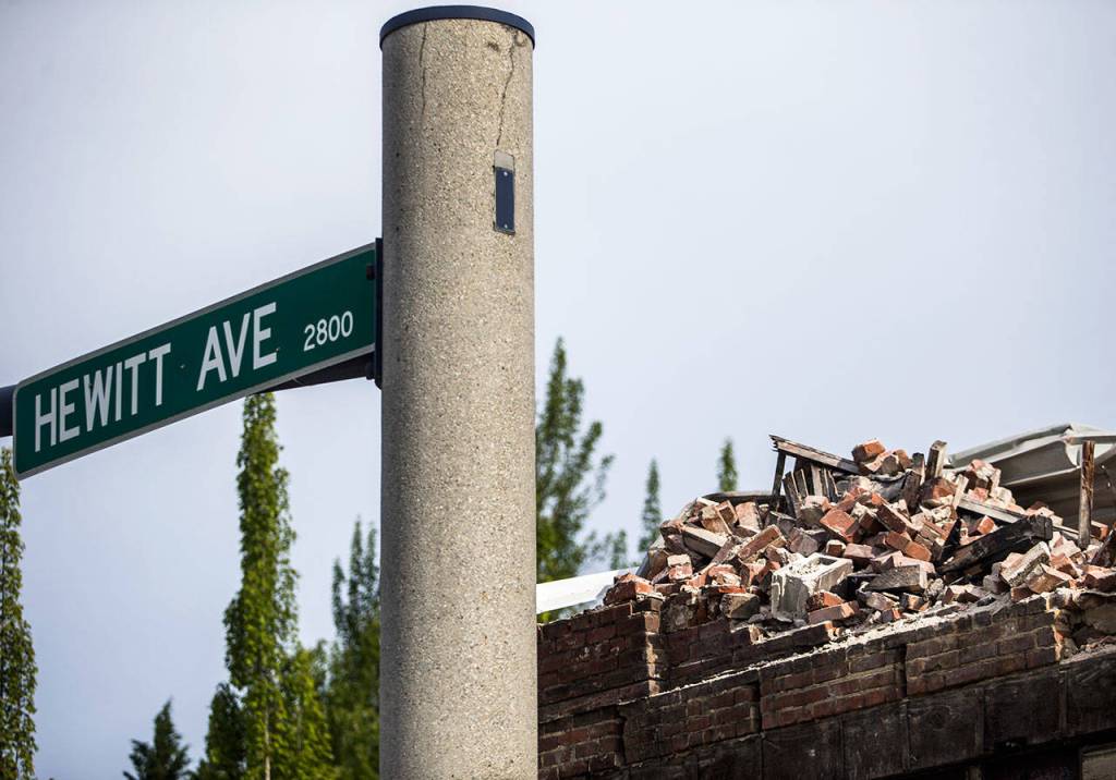 Crumbled bricks can be seen next to the Hewitt Ave sign Friday in Everett. (Olivia Vanni / The Herald)