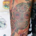 Nick Chavira shows a finished tattoo while posing for photos during a break from Mary Joy Scott working on the outline of one of his tattoos at Ed Hardys Tattoo City in San Francisco. (AP Photo/Jeff Chiu)