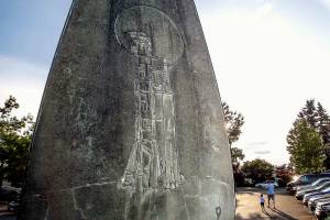 On the backside of the Edmonds statue created by artist Howard Duell is an image of the Saturn V rocket that carried three astronauts aloft on their way to the moon in 1969. (Dan Bates / The Herald)