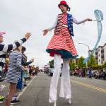 Sarah Liane Foster high-fives kids during the Colors of Freedom Fourth of July Parade on July 4 in Everett. (Olivia Vanni / The Herald)