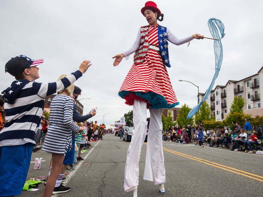 Sarah Liane Foster high-fives kids during the Colors of Freedom Fourth of July Parade on July 4 in Everett. (Olivia Vanni / The Herald)