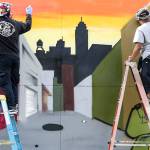 Urban artists from Under the Influence paint a mural in Snohomish on July 4. (Kevin Clark / The Herald)
