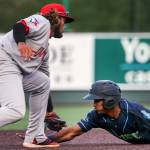 Vancouvers Ronny Brito tags out AquaSoxs Miguel Perez at second base at Funko Field in Everett on July 11. (Kevin Clark / The Herald)