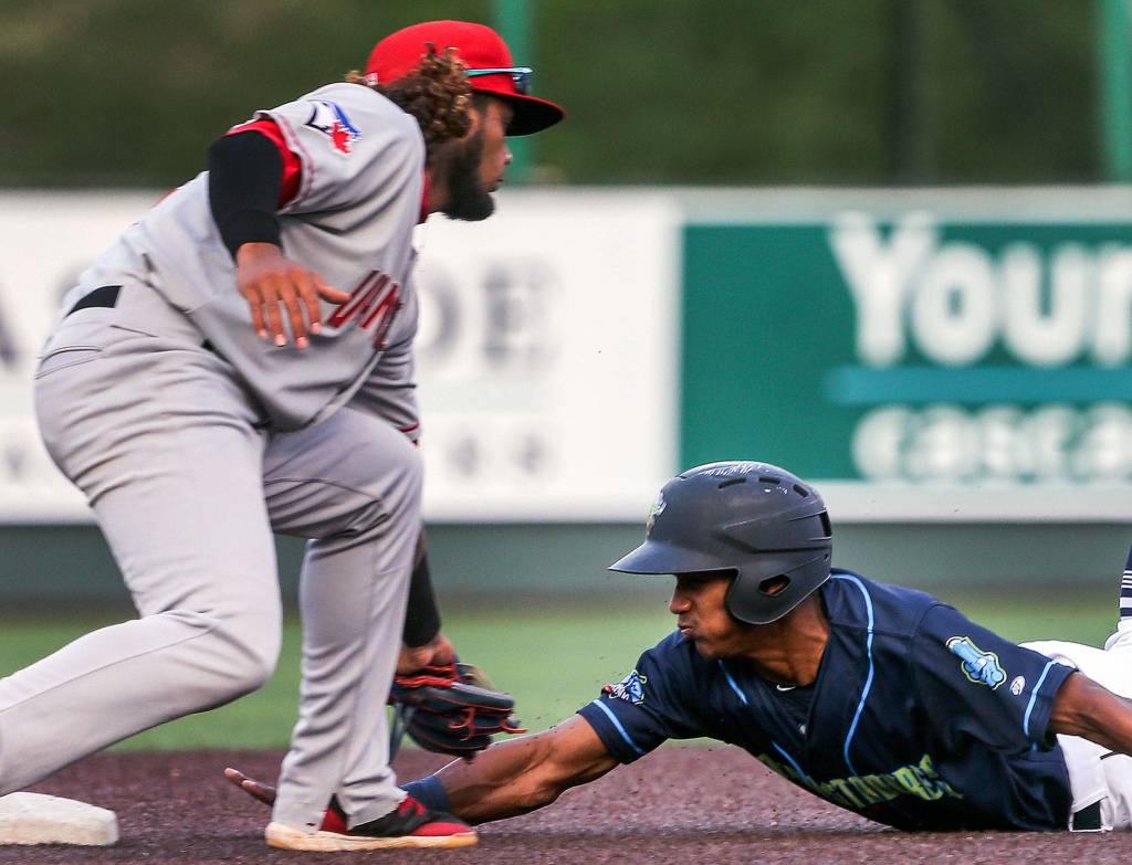 Vancouvers Ronny Brito tags out AquaSoxs Miguel Perez at second base at Funko Field in Everett on July 11. (Kevin Clark / The Herald)