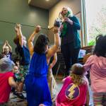 Kids jump around for a rocket themed song being played by Shannon Horrocks during Ms. Shannons story time at the Snohomish Library on May 15 in Everett. (Olivia Vanni / The Herald)