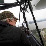 Pilot Dan Tarasievich looks down at the city of Langley after a coffee stop at Mukilteo Coffee Roasters as he flies home to Arlington on April 20 above Langley. (Andy Bronson / The Herald)