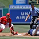 Seattle Mariners Dylan Moore (right) steals second base as Los Angeles Angels shortstop David Fletcher awaits the throw during the second inning of Sundays game in Anaheim, California. (AP Photo/Marcio Jose Sanchez)
