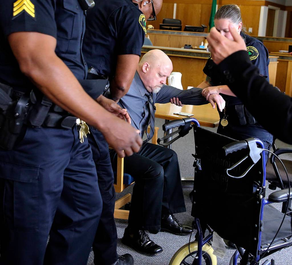 William Talbott II is helped to a wheelchair by Snohomish County sheriffs deputies June 28 after being found guilty of murder. (Kevin Clark/The Herald)