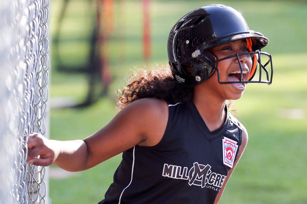 Mill Creek Little Leagues Elena Eigner celebrates during a drill on July 16 at Jackson High School in Mill Creek. (Kevin Clark / The Herald)