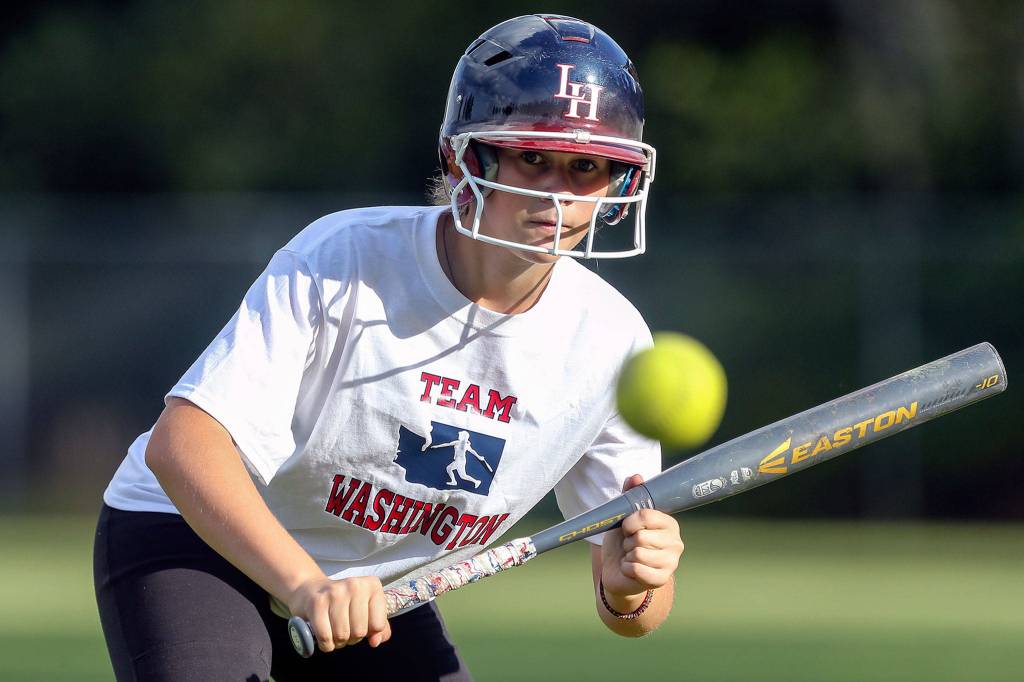 Mill Creek Little League catcher Leneyah Mitchell works on bunting during practice on July 16 at Jackson High School in Mill Creek. (Kevin Clark / The Herald)