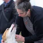 Christi Hnat greets her dog Darwin at Point Edwards Park in Edmonds on April 4. (Kevin Clark / The Herald)