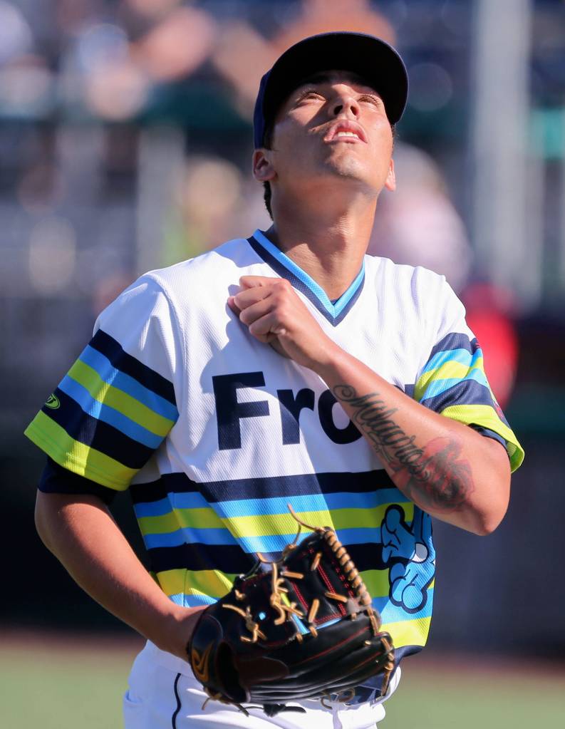 Jorge Benitez of the Everett AquaSox makes his way to the dugout during a game against the Spokane Indians on Sunday at Funko Field in Everett. (Kevin Clark / The Herald)