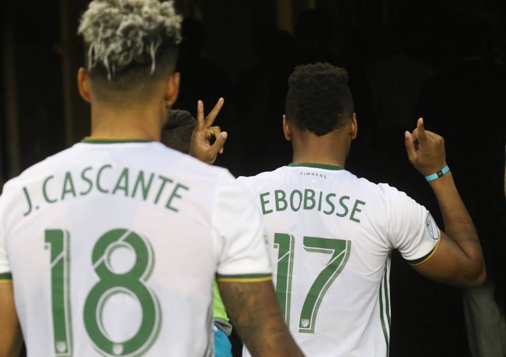 Jeremy Ebobisse holds up the final score as he walks into the locker room after the Seattle Sounders lost 2-1 to the Portland Timbers at CenturyLink Field on Sunday, July 21, 2019 in Seattle, Wash. (Andy Bronson / The Herald)