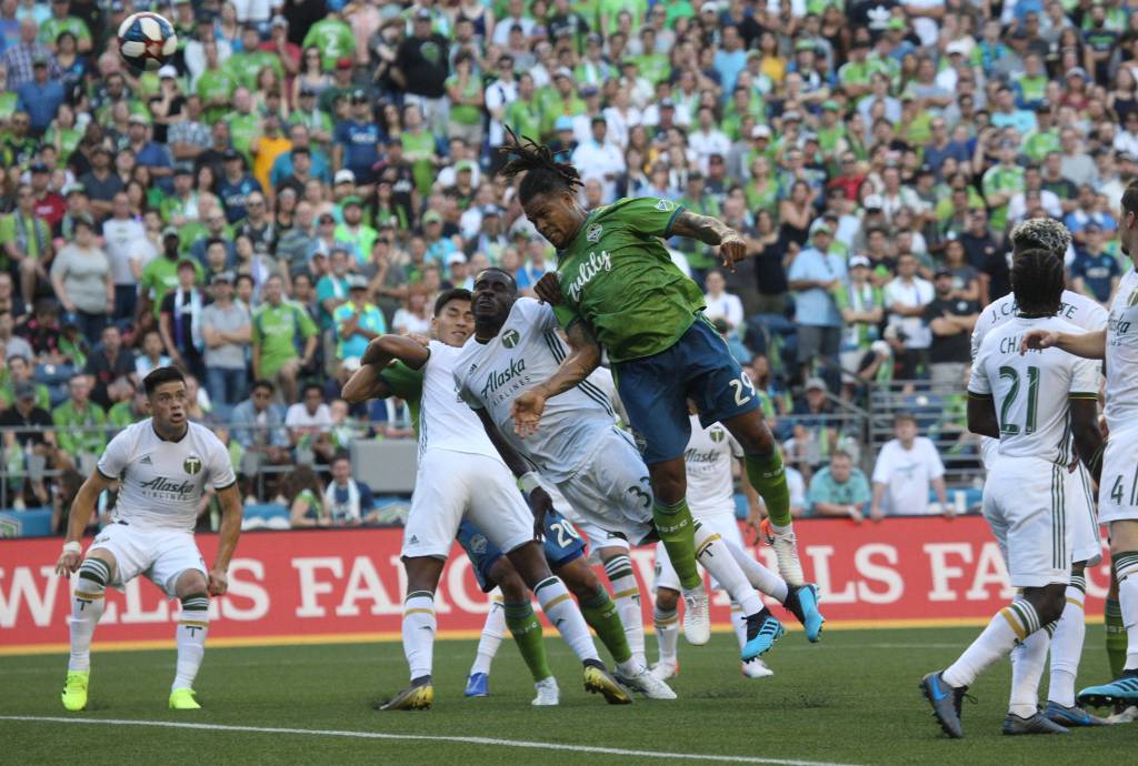 Roman Torres fires a header toward the goal on a corner kick as the Seattle Sounders lost 2-1 to the Portland Timbers at CenturyLink Field on Sunday, July 21, 2019 in Seattle, Wash. (Andy Bronson / The Herald)