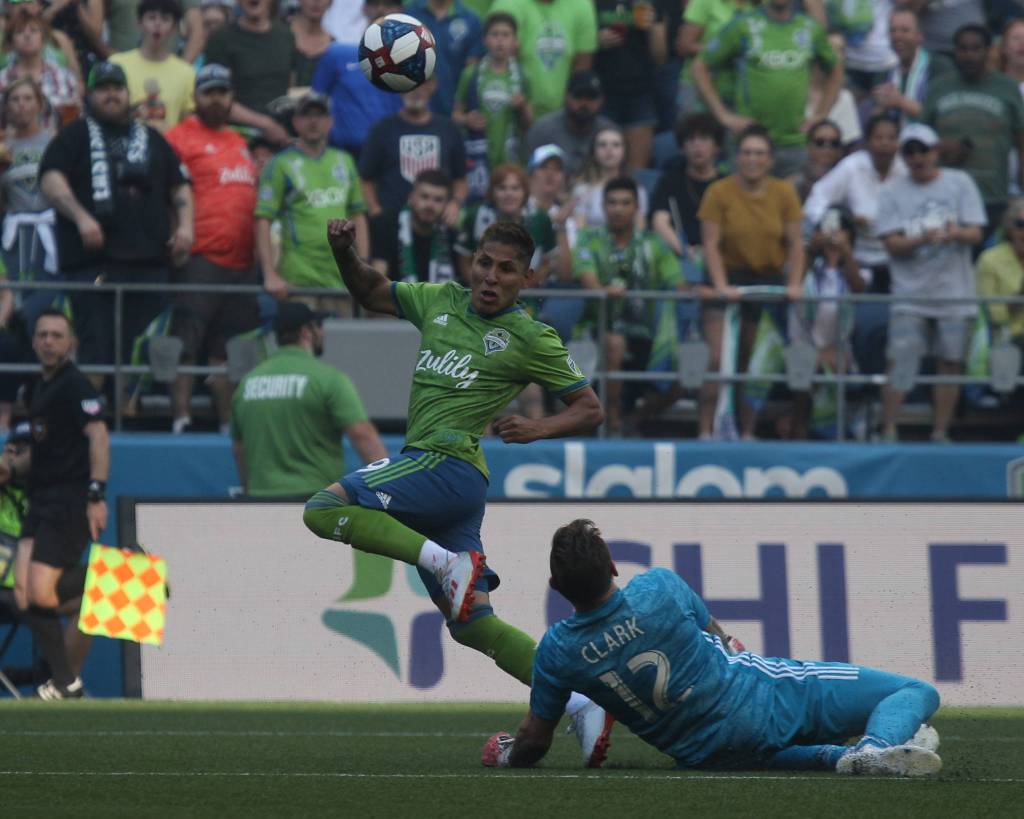 Seattles Raul Ruidiaz tries to score a gaol after passing Portland goalie Jeff Attinella as the Seattle Sounders lost 2-1 to the Portland Timbers at CenturyLink Field on Sunday, July 21, 2019 in Seattle, Wash. (Andy Bronson / The Herald)