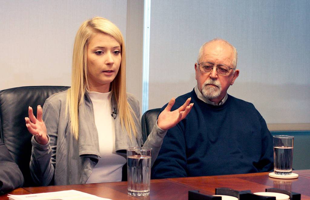 Britt Jakobsen (left) speaks to reporters in Seattle on Nov. 21, 2018. She was in the passenger seat when her boyfriend, Nickolas Peters, was shot by a Snohomish County sheriffs deputy. At right is her father, Ken Jakobsen. (Zachariah Bryan / Herald file)