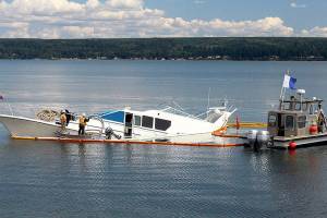 Partially sunk yacht in Hood Canal towed; 8 escaped safely