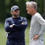 Seahawks head coach Pete Carroll (right) talks with general manager John Schneider following an organized team activity on June 6, 2019, in Renton. (AP Photo/Ted S. Warren)