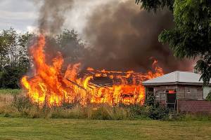 Flames destroy barn at Arlington park