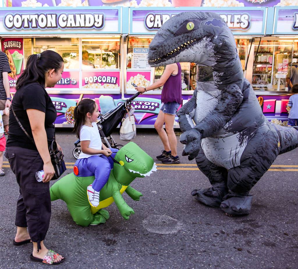 Dinosaurs abound Friday afternoon during Lake Stevens Aquafest. (Kevin Clark / The Herald)