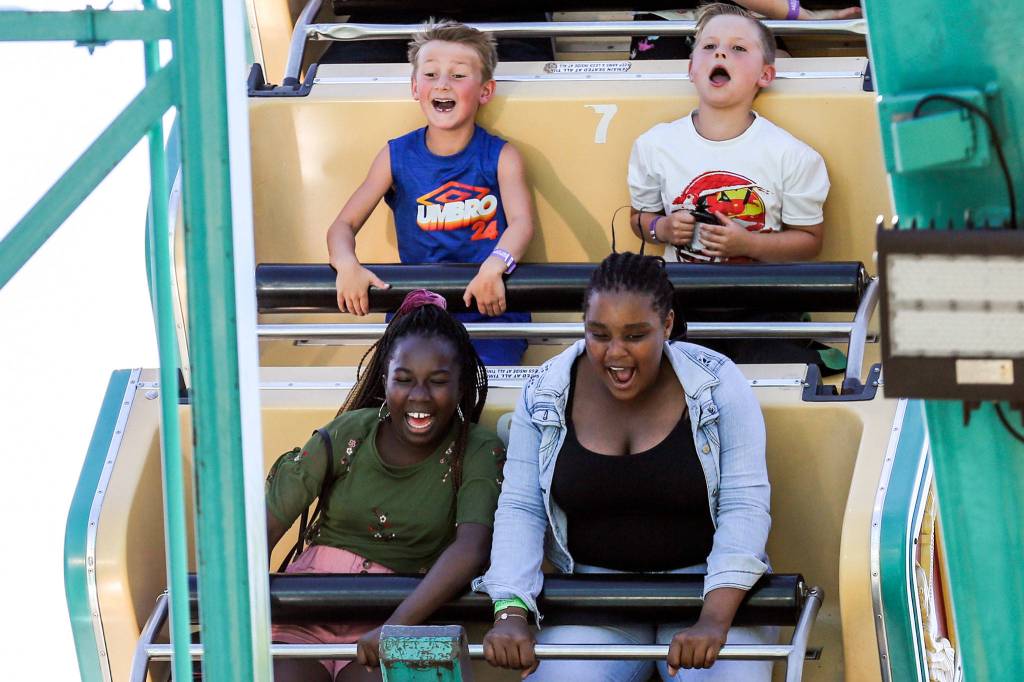 Fair goers enjoy the rides Friday afternoon during Lake Stevens Aquafest. (Kevin Clark / The Herald)