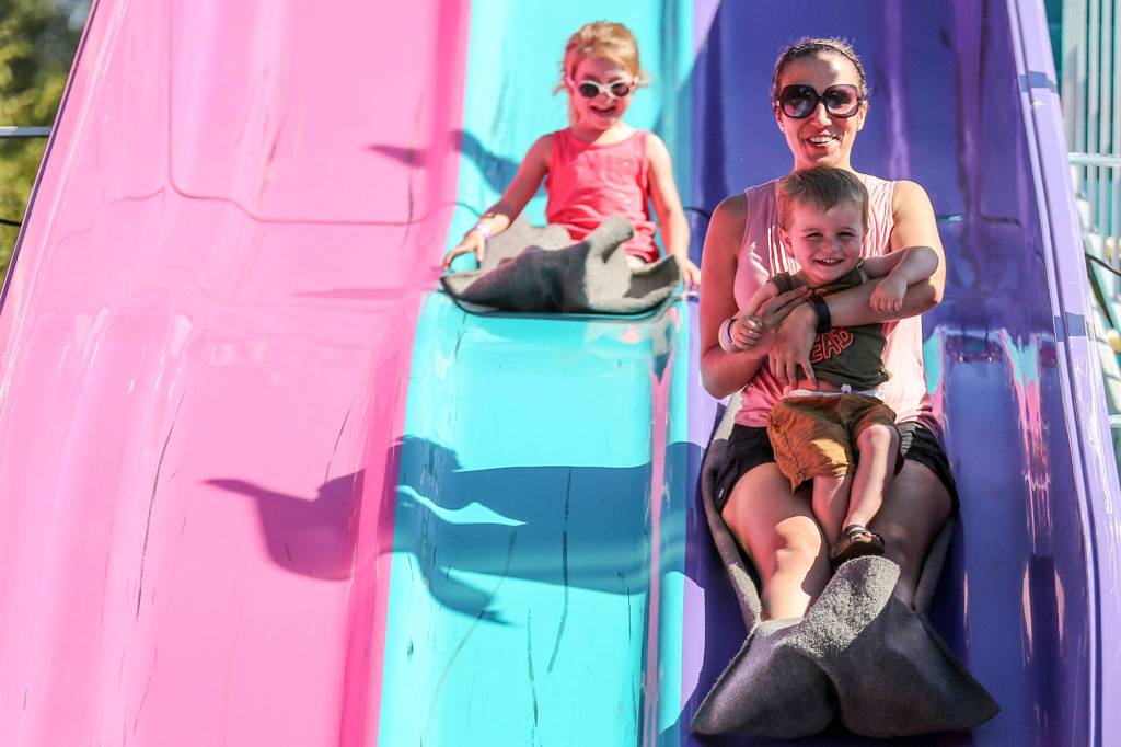 Fair goers enjoy the slide Friday afternoon during Lake Stevens Aquafest. (Kevin Clark / The Herald)