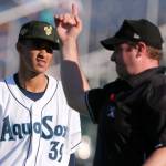 The umpire signals a home run off AquaSox pitcher Deivy Florido during a game against the Dust Devils on July 28, 2019, at Funko Field at Everett Memorial Stadium. (Kevin Clark / The Herald)