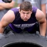Lake Stevens Wyatt Hall races in the tire flip relay Saturday afternoon during the Cougar Championship Passing Tournament at Lakewood High School in Marysville on July 27, 2019. (Kevin Clark / The Herald)