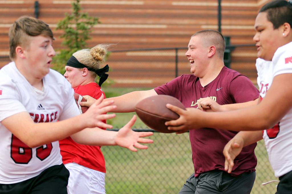 Offensive linemen race in the 4x100 meter relays Saturday afternoon during the Cougar Championship Passing Tournament at Lakewood High School in Marysville on July 27, 2019. (Kevin Clark / The Herald)