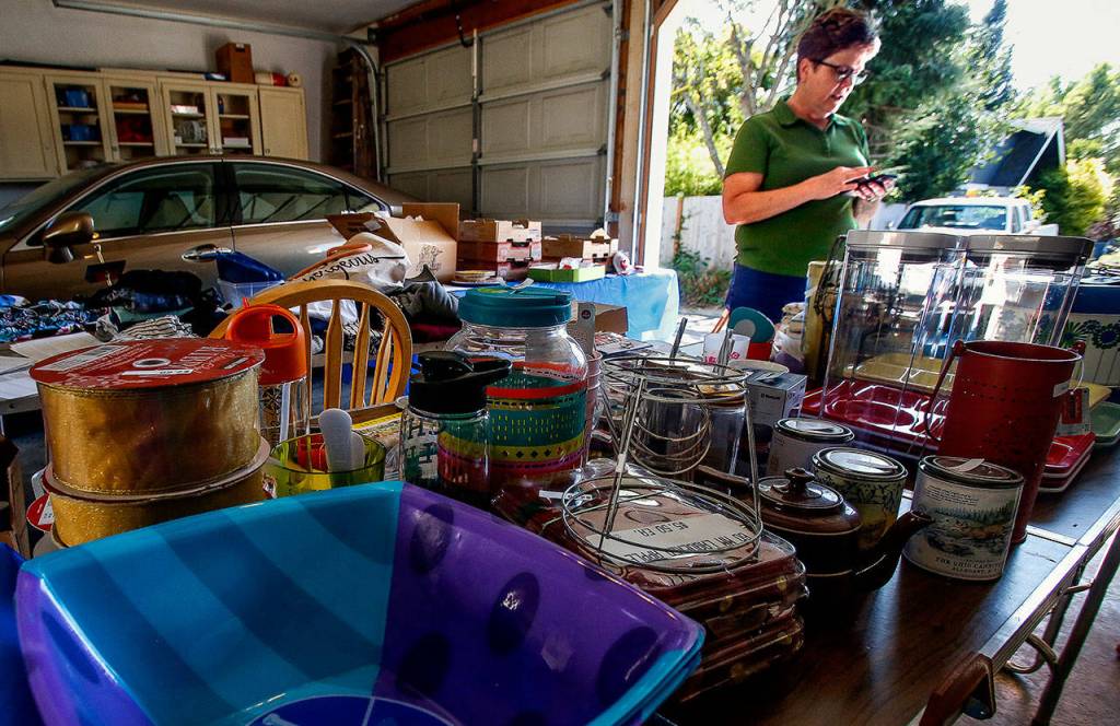 Carol Wheeler is busy preparing for Saturdays Mother of All Garage Sales in Everetts Northwest Neighborhood. For years, Wheeler did the sale as a fundraiser for a Girl Scout troop. She sells vintage Christmas items, antique teacups, clothing and other items. (Dan Bates / The Herald)