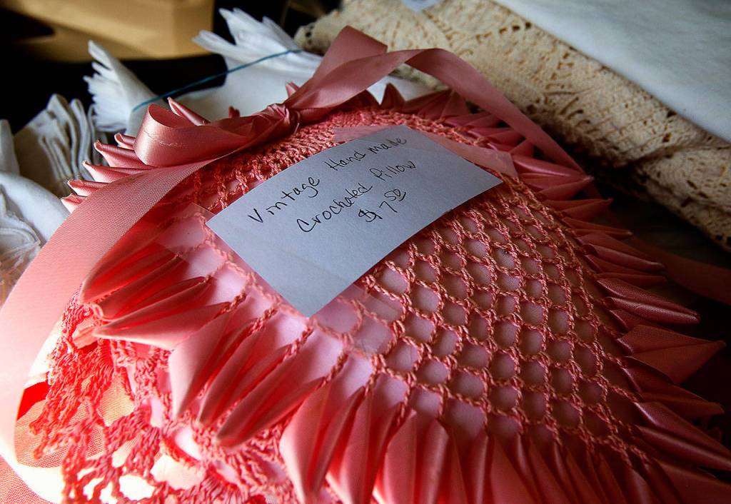 Hand-crocheted linens and other goods are among Carol Wheelers offerings for the Mother of All Garage Sales. (Dan Bates / The Herald)