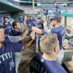 Seattles Kyle Seager (right) is congratulated in the dugout after scoring on Tom Murphys single during the seventh inning of the Mariners 8-5 win over Texas on Tuesday in Arlington, Texas. (AP Photo/Tony Gutierrez)