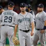 Mariners starter Wade LeBlanc (center) walks to the dugout after turning the ball over to manager Scott Servais (29) during the fifth inning of a game against the Rangers on July 31, 2019, in Arlington, Texas. (AP Photo/Tony Gutierrez)