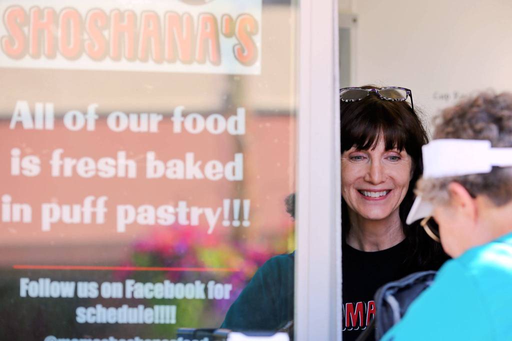 Linda Van Eyck serves a customer from her food truck, Mama Shoshanas, during Kla-Ha-Yah Days. (Kevin Clark / The Herald)
