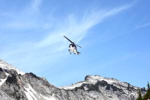 A helicopter crew scours rough terrain Sunday, Aug. 5, at Vesper Peak, in the search for missing hiker Sam Sayers, of Seattle. She went missing Aug. 1, on the hike about 30 miles east of Granite Falls. (Caleb Hutton / The Herald)
