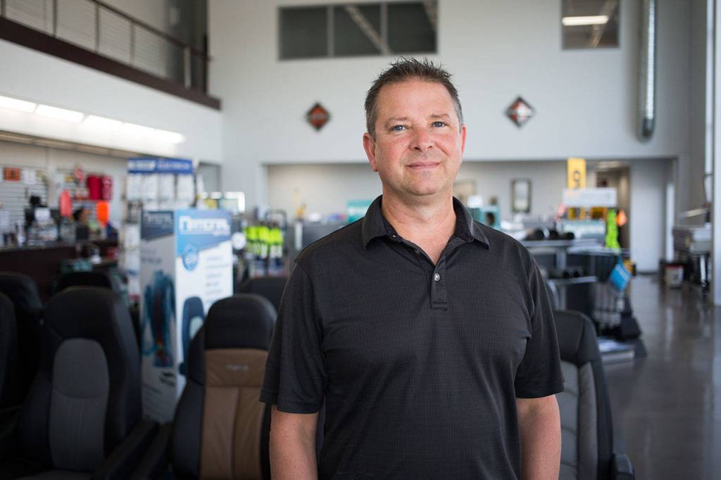 Les Nelson, a U.S. Navy veteran, has been the sales-and-lease manager at Motor Trucks in Everett for 20 years. (Andy Bronson / The Herald)
