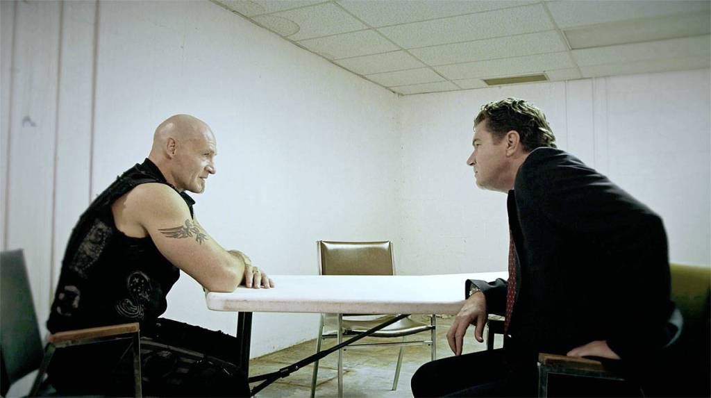 Ansel Schneider (Ralf Scheepers) is interrogated by Detective Armitage (Kevin Cusick) in Devils Five. (Mantaray Pictures LLC/Cool Creative/HERMANOfilms)