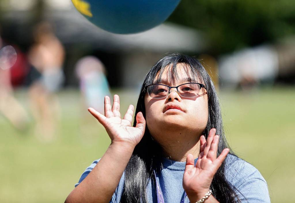 Bre Baylon slaps a bouncy ball back to Megan Pfohl, 20, early Wednesday after arriving at Camp Prov in Forest Park. (Dan Bates / The Herald)