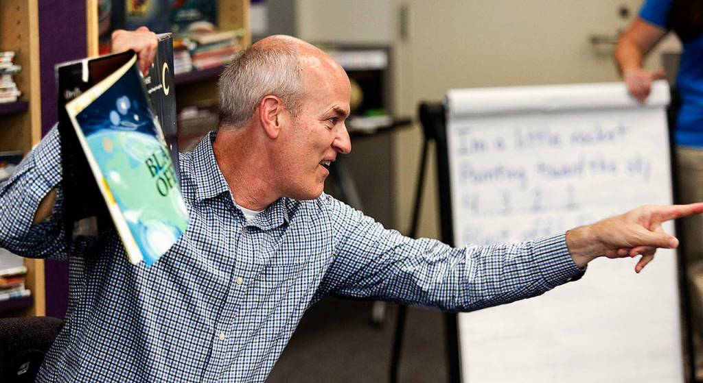 In lively fashion, Congressman Rick Larsen takes a question from one of several dozen kids listening to him read the illustrated book Penguinaut! on Thursday at Sno-Isles Marysville Library while visiting with Librarian of Congress Carla Hayden. (Dan Bates / The Herald)