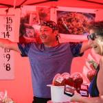 Bubba of Bubbas Salsa greets the new location with Peggy Webb (right) Sunday morning at Everett Farmers Market in Everett in August 4, 2019. (Kevin Clark / The Herald)